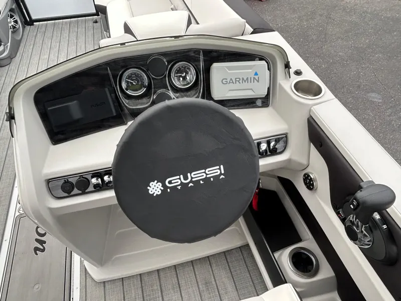 Slide: The Image of 2024 Avalon LSZ 2585 RL boat dashboard with Gussi Italia steering wheel and Garmin navigation. - 19