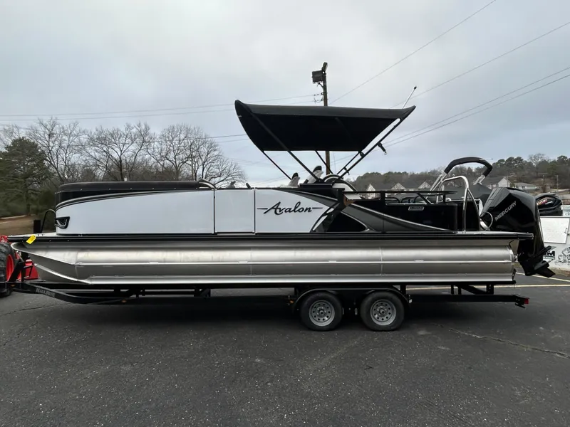 Slide: The Image of 2024 Avalon LSZ 2585 RL pontoon boat on a trailer. - 4