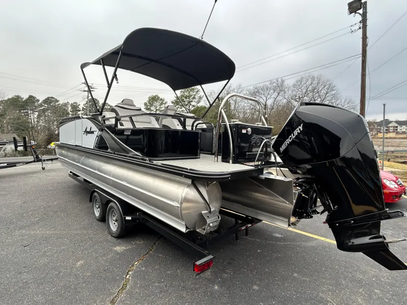 Slide: The Image of 2024 Avalon LSZ 2585 RL pontoon boat with Mercury outboard engine on trailer. - 5