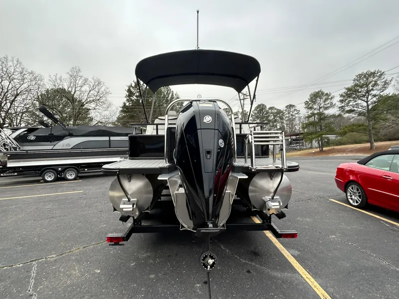 Slide: The Image of 2024 Avalon LSZ 2585 RL pontoon boat with outboard motor in parking lot. - 6