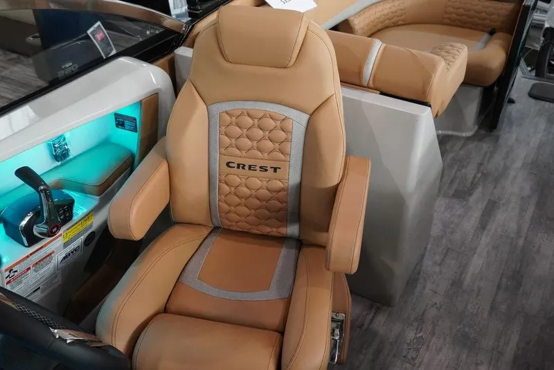 Slide: The Image of 2024 Crest Continental 250 SLC CP3 boat interior with luxurious captain's chair and control panel. - 6