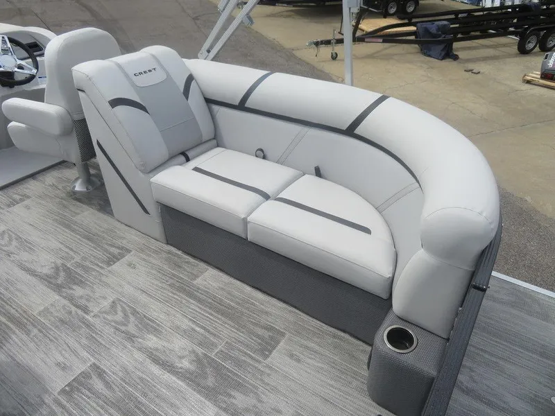 Slide: The Image of 2024 Crest CLASSIC LX 240 SLC boat interior with plush seating and modern design. - 10