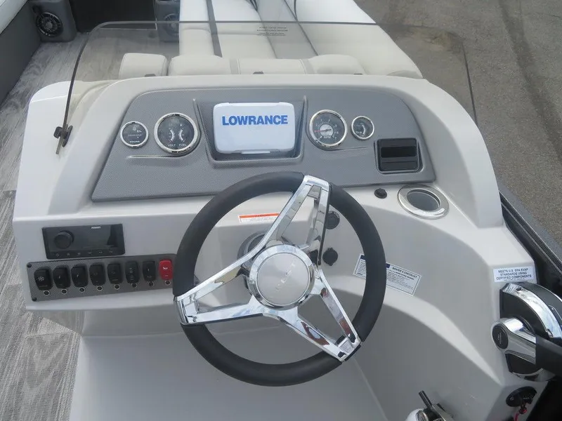 Slide: The Image of 2024 Crest CLASSIC LX 240 SLC boat dashboard with Lowrance display and steering wheel. - 7