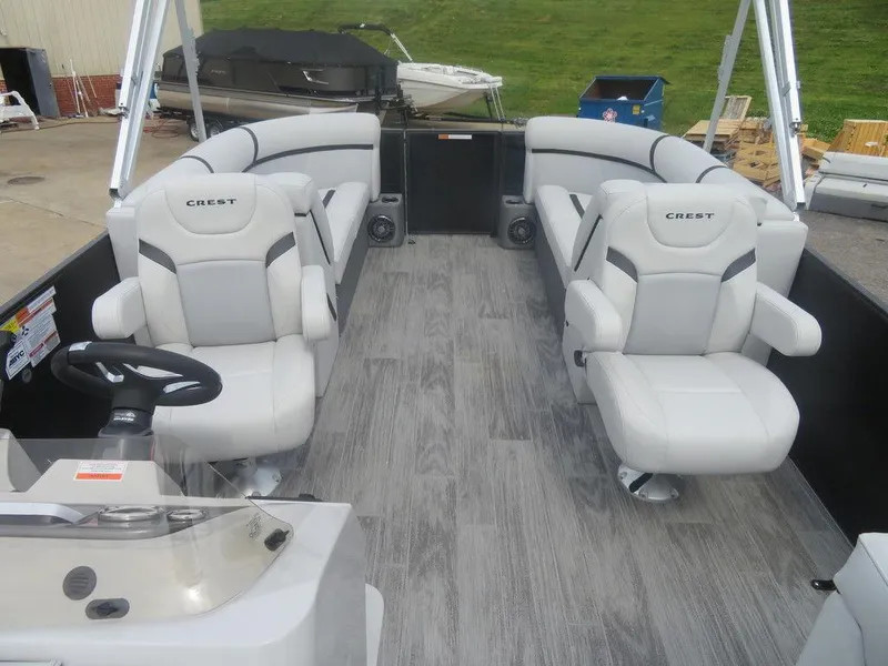 Slide: The Image of 2024 Crest CLASSIC LX 240 SLC pontoon boat interior with gray seating and flooring. - 8