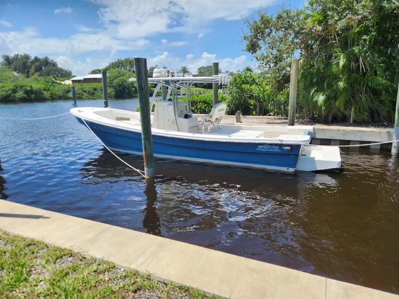 Slide: The Image of 2013 Panga Center Console boat docked on a sunny day. - 0