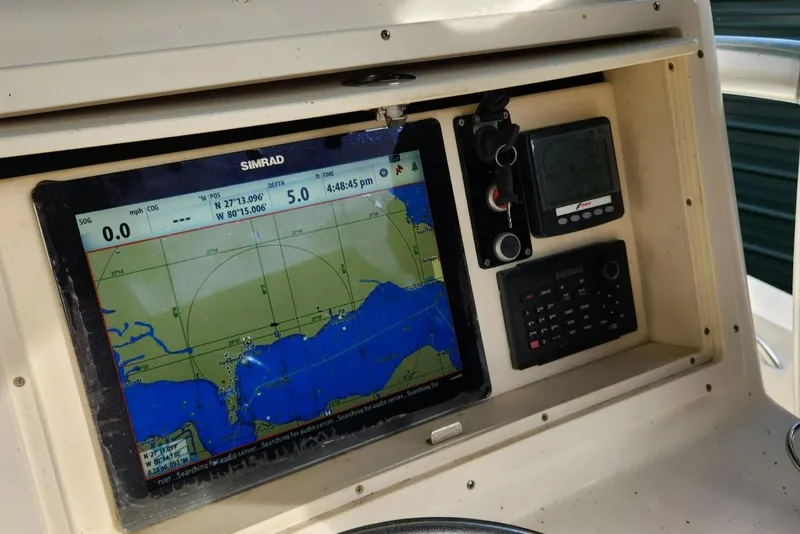 Slide: The Image of 2013 Panga Center Console boat with Simrad navigation system and control panel. - 12