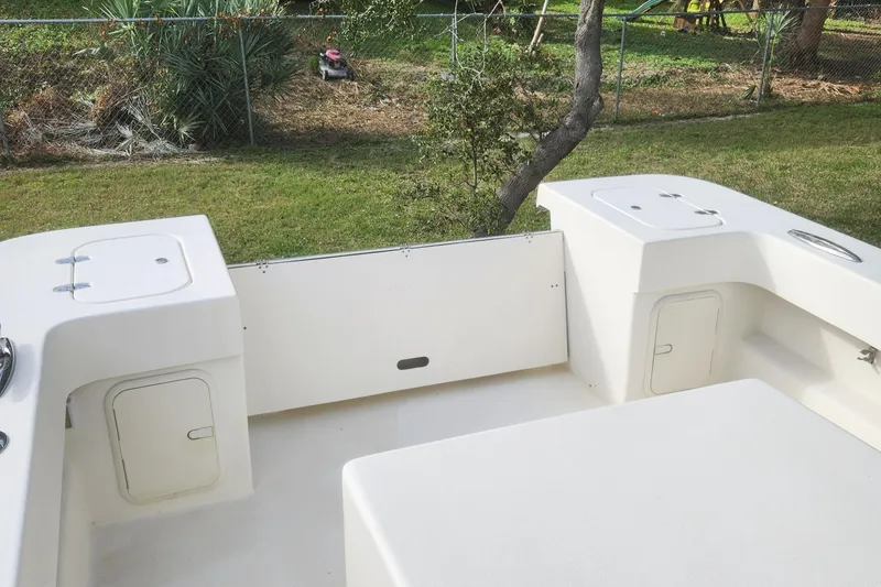 Slide: The Image of 2013 Panga Center Console boat interior with storage compartments and seating. - 15