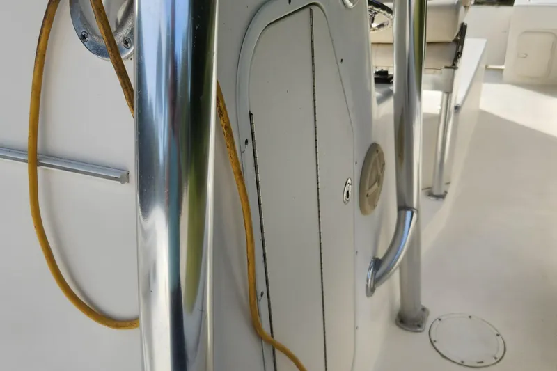 Slide: The Image of Close-up of 2013 Panga Center Console boat interior with chrome railing and yellow cable. - 18