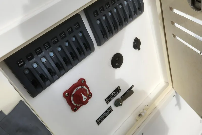 Slide: The Image of Control panel of a 2013 Panga Center Console boat with switches and dials. - 19