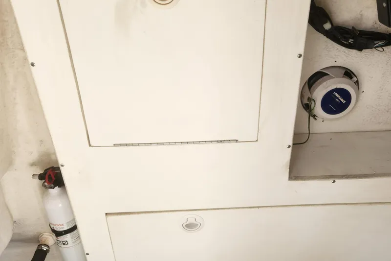 Slide: The Image of 2013 Panga Center Console boat interior with storage compartments and fire extinguisher. - 21