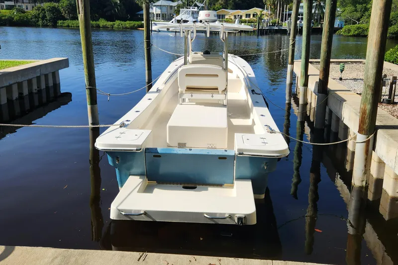 Slide: The Image of 2013 Panga Center Console boat docked on a calm river. - 3