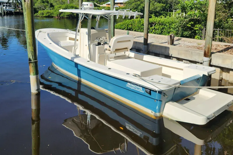 Slide: The Image of 2013 Panga Center Console boat docked on calm water. - 4
