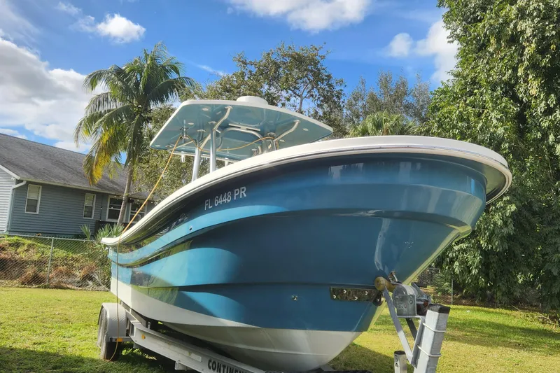Slide: The Image of 2013 Panga Center Console boat on trailer in a tropical yard. - 5