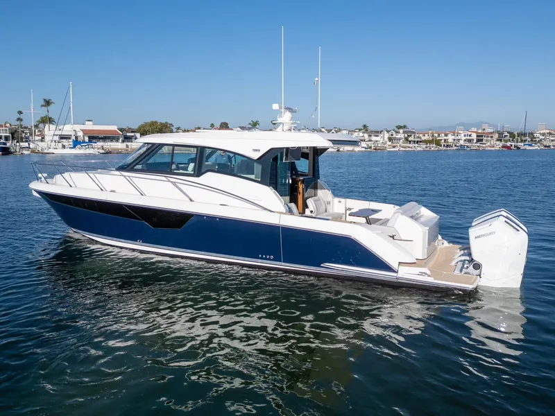 Slide: The Image of 2024 Tiara Yachts 48 LE luxury boat on calm water. - 2