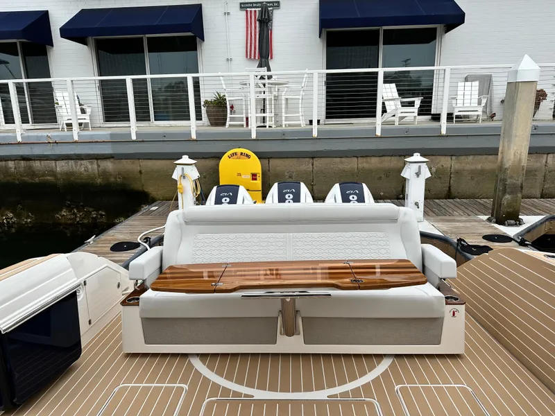 Slide: The Image of 2024 Tiara Yachts 48 LE luxury boat with seating and outboard engines at dock. - 38