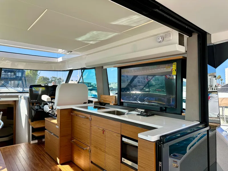 Slide: The Image of Luxurious interior of 2024 Tiara Yachts 48 LE, featuring modern kitchen and helm station. - 43