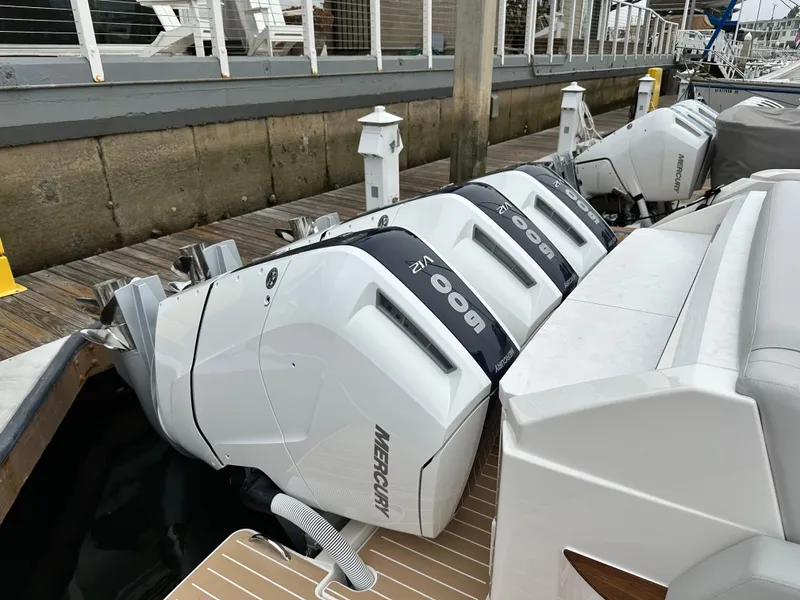 Slide: The Image of 2024 Tiara Yachts 48 LE with triple Mercury 600 outboard engines docked. - 9