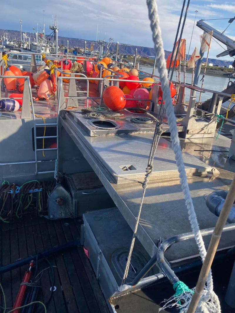 Slide: The Image of 1979 Custom Longline/Tender/Crabber boat with fishing gear and buoys docked at a harbor. - 4