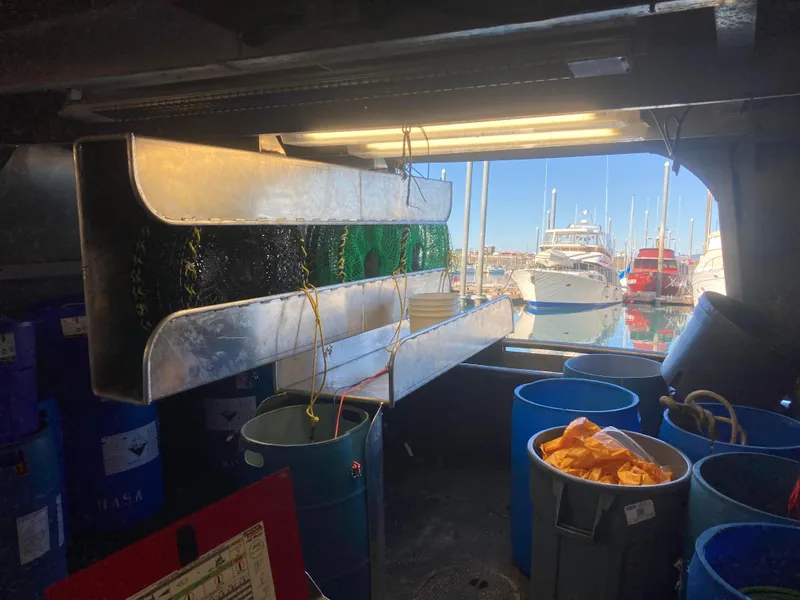 Slide: The Image of Interior of a 1979 Custom Longline/Tender/Crabber boat with fishing equipment and harbor view. - 6
