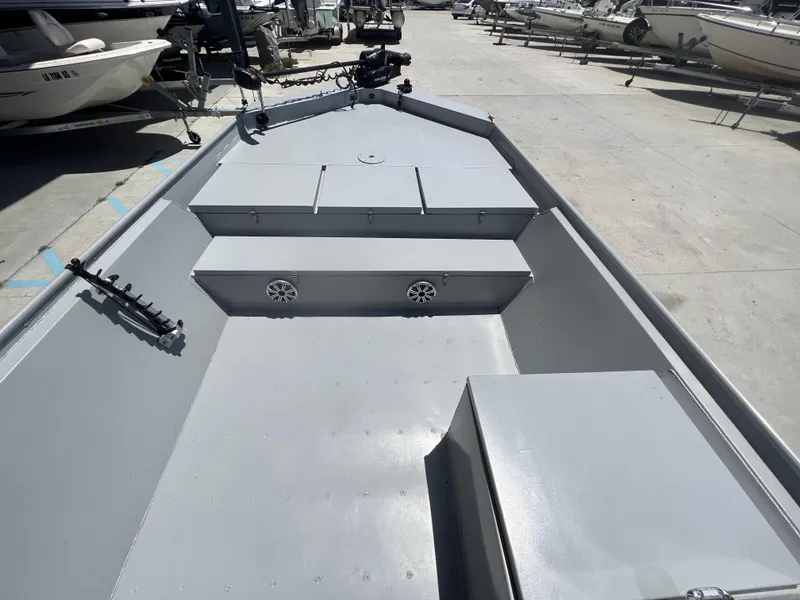 Slide: The Image of 2021 Southfork 20X72 boat interior, gray deck, storage compartments, and rod holder. - 8