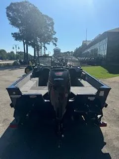 Slide: The Image of 2024 Tracker Pro Guide V-175 WT boat, rear view, parked outdoors on a sunny day. - 11