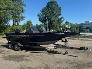 Slide: The Image of 2024 Tracker Pro Guide V-175 WT boat on trailer, parked outdoors. - 12