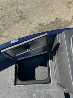 Slide: The Image of 2024 Tracker Pro Guide V-175 WT boat storage compartment, open on a carpeted deck. - 4