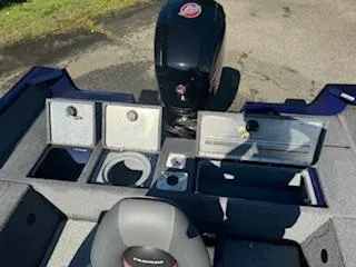 Slide: The Image of 2024 Tracker Pro Guide V-175 WT boat interior with storage compartments and motor. - 8