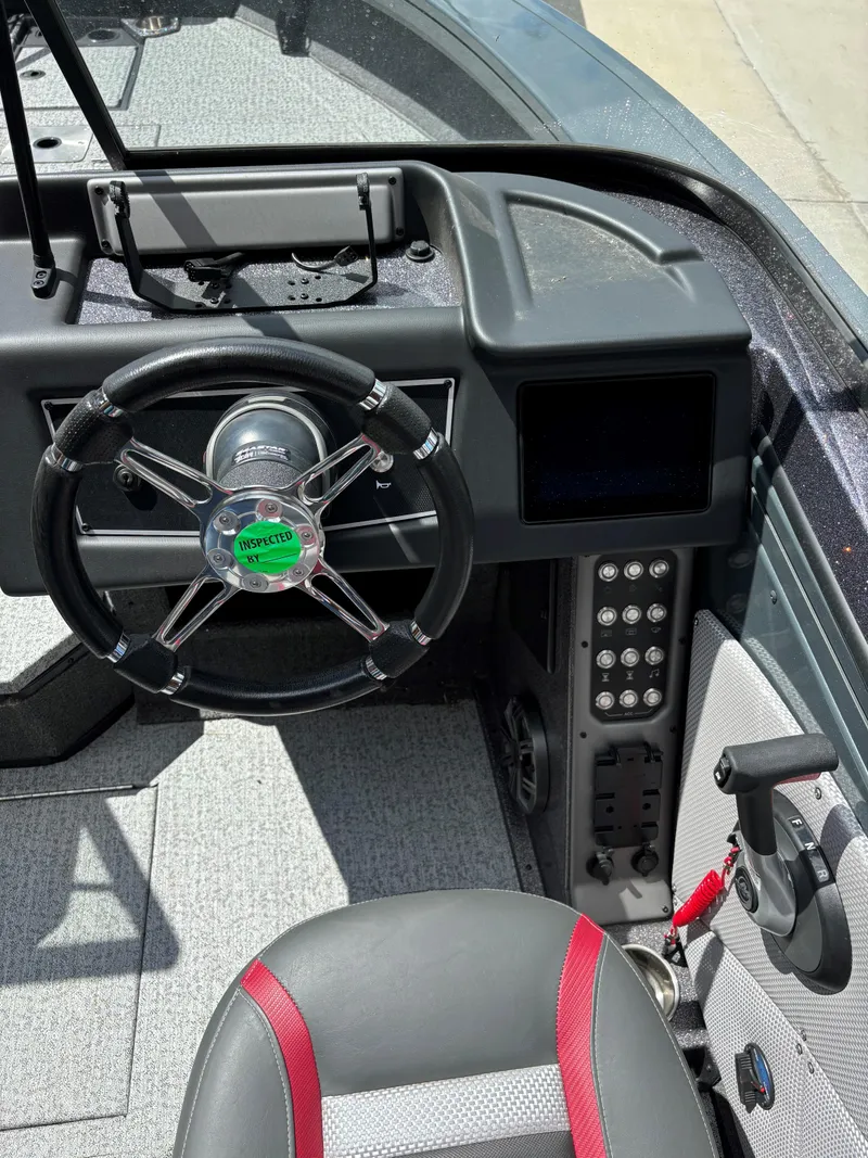 Slide: The Image of 2024 Ranger VX1988 WT boat dashboard with steering wheel and control panel. - 6