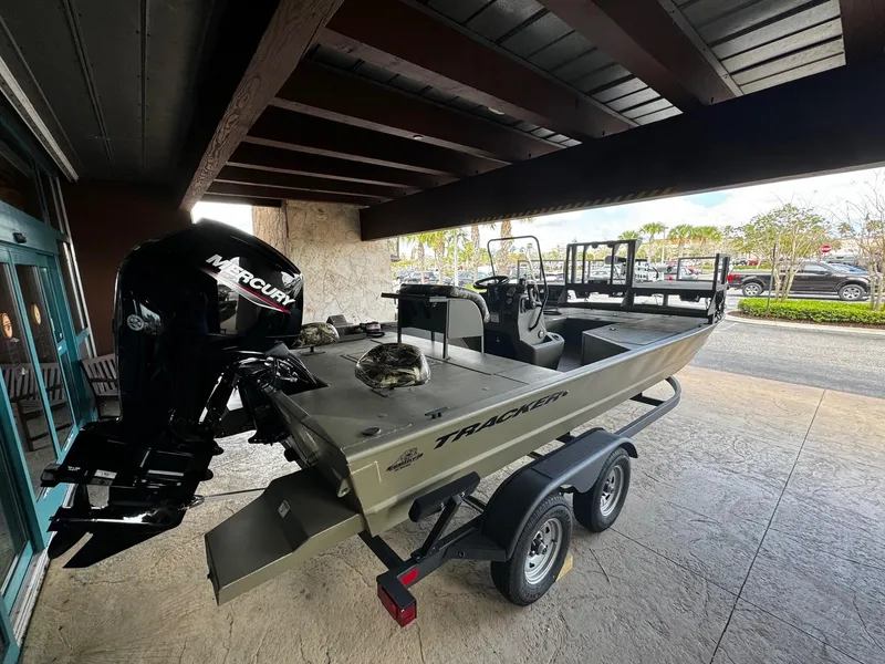 Slide: The Image of 2024 Tracker Grizzly 2072 CC Sportsman boat on trailer with Mercury outboard motor. - 3