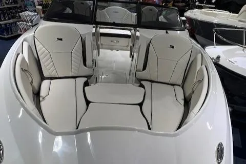 Slide: The Image of 2024 Stingray 230SX boat interior with white leather seating and modern design. - 10