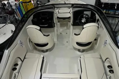 Slide: The Image of 2024 Stingray 230SX boat interior with white seating and modern dashboard. - 12