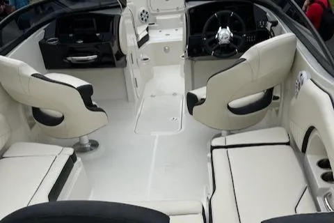 Slide: The Image of 2024 Stingray 230SX boat interior with white seating and modern dashboard. - 2