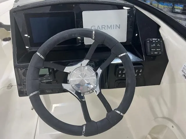 Slide: The Image of 2024 Stingray 230SX boat dashboard with Garmin navigation system and steering wheel. - 5