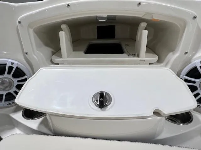 Slide: The Image of 2024 Stingray 230SX boat storage compartment with speakers. - 7