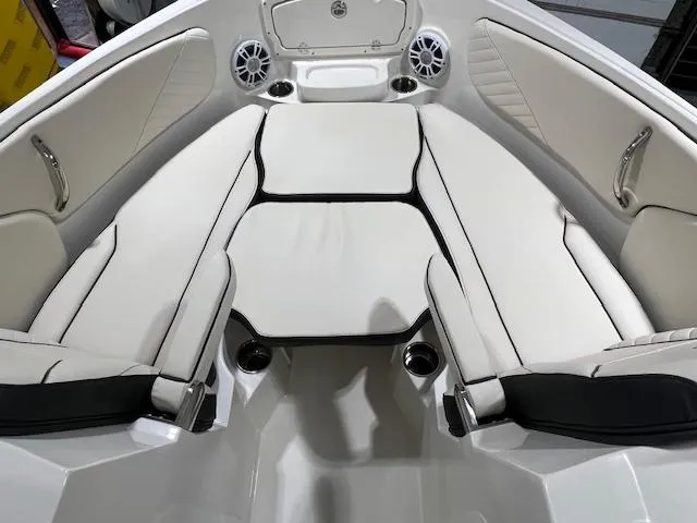 Slide: The Image of 2024 Stingray 230SX boat interior with white cushioned seating and built-in speakers. - 8