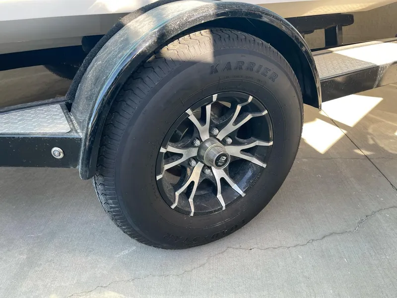 Slide: The Image of Trailer wheel of 2024 Stingray 192 SC boat, featuring Karrie tire and alloy rim. - 11