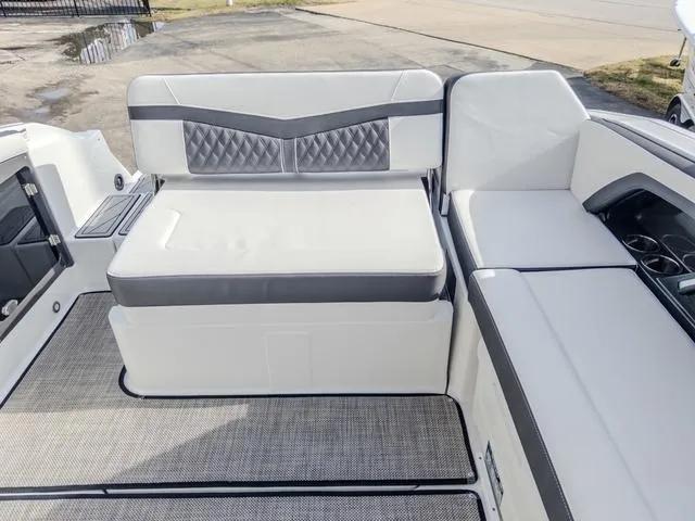 Slide: The Image of 2024 Monterey 258 SS boat interior with white and gray seating. - 16