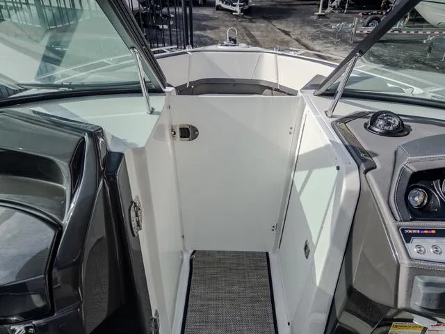 Slide: The Image of 2024 Monterey 258 SS boat interior with sleek dashboard and open bow area. - 29
