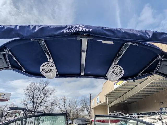 Slide: The Image of 2024 Monterey 258 SS boat canopy with speakers, under a clear sky. - 35