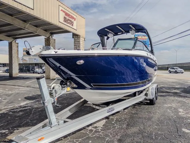 Slide: The Image of 2024 Monterey 258 SS boat on trailer at dealership, showcasing sleek design and blue exterior. - 4