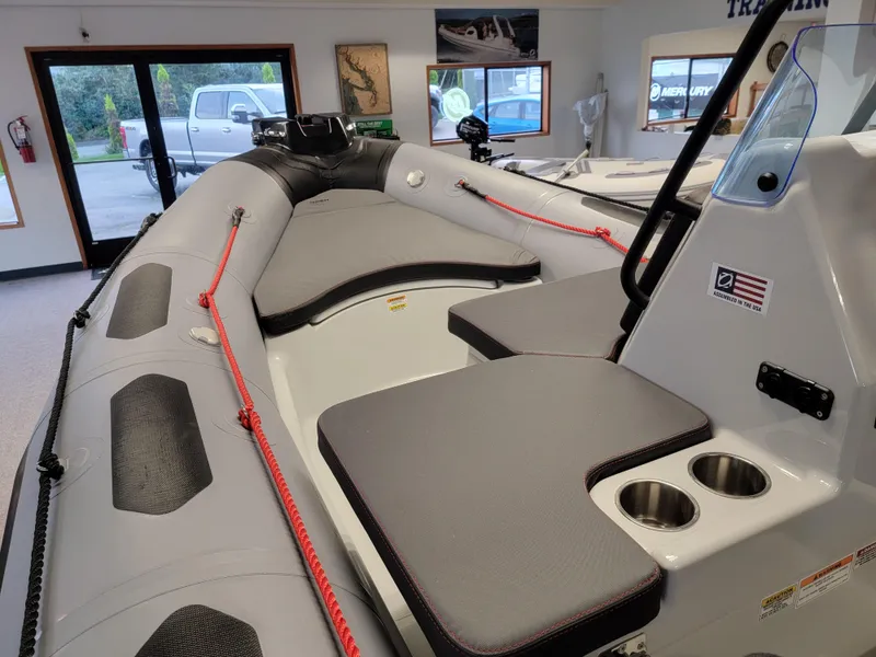 Slide: The Image of 2024 Zodiac Open 4.8 inflatable boat interior with seating and cup holders. - 12