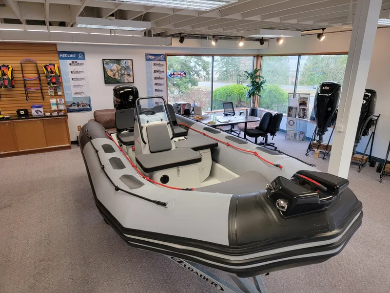Slide: The Image of 2024 Zodiac Open 4.8 inflatable boat displayed in showroom setting. - 3