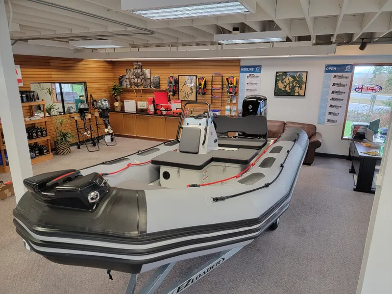 Slide: The Image of 2024 Zodiac Open 4.8 inflatable boat displayed in showroom. - 4