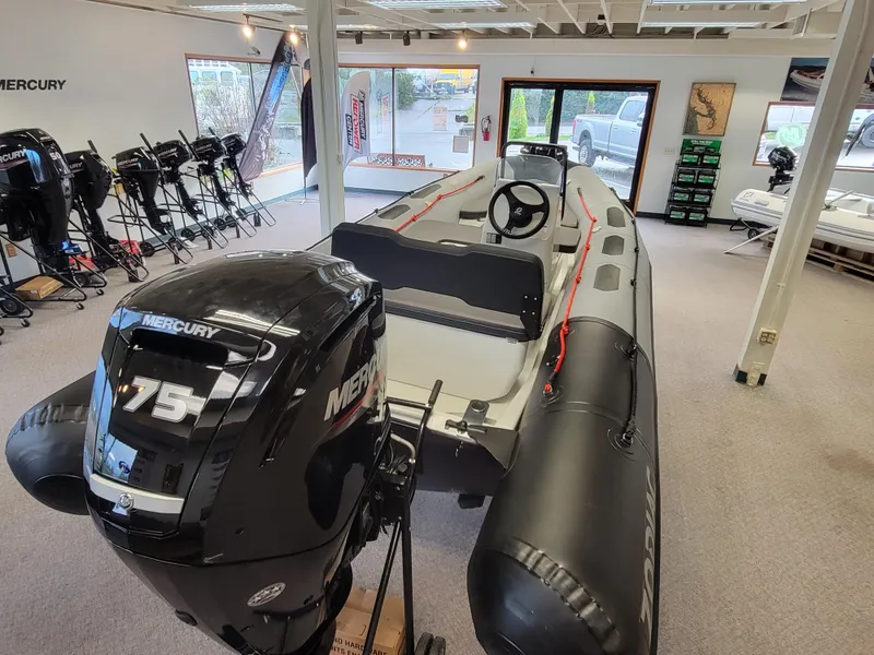 Slide: The Image of 2024 Zodiac Open 4.8 boat with Mercury 75 engine in showroom. - 6