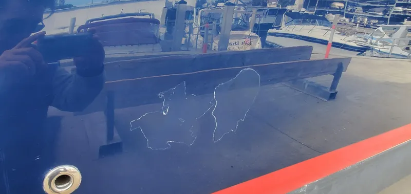 Slide: The Image of 2013 Cobalt 24SD boat with hull scratch, docked at marina. - 17