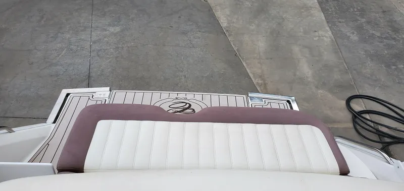 Slide: The Image of Rear view of a 2013 Cobalt 24SD boat with cushioned seating and deck details. - 21