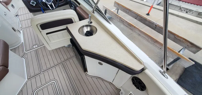 Slide: The Image of 2013 Cobalt 24SD boat interior with sink, beige countertop, and stylish flooring. - 24