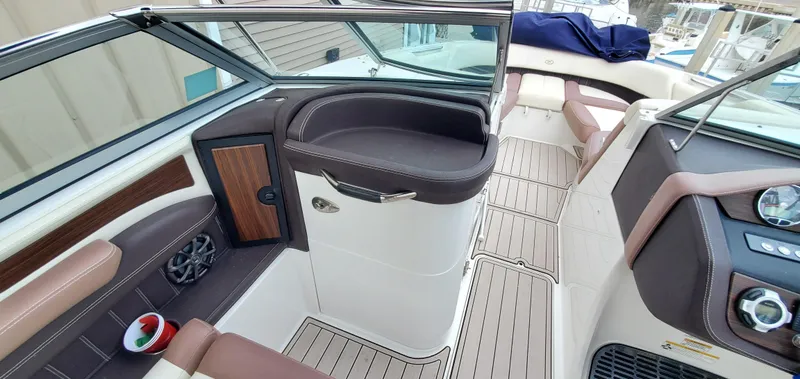 Slide: The Image of Interior of a 2013 Cobalt 24SD boat, featuring sleek seating and modern dashboard design. - 27