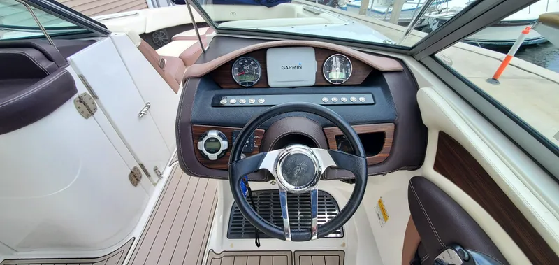 Slide: The Image of Interior view of 2013 Cobalt 24SD boat dashboard with Garmin navigation system. - 30